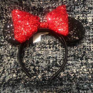 Disney Minnie black sequins ears w/ red bow.